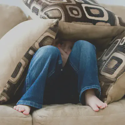 Kid Hiding in Pillows