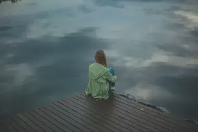 Woman on Dock Looking Over Water