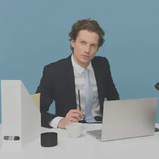 Man Sitting in Front of Desk