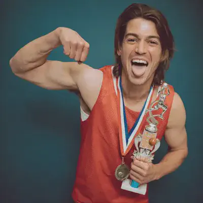 Man Flexing Muscles with Trophy