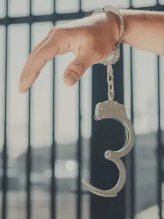 Person with One Handcuff On