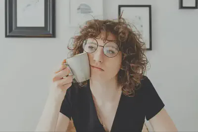 Woman Holding Mug on Face
