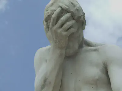 Hand Over Face Statue
