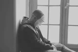 Man Wearing Mask Near Window