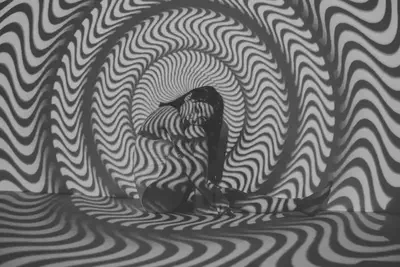Woman Sitting with Striped Projection