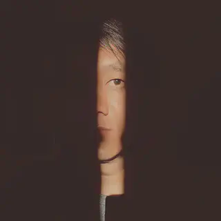 Woman Standing in Shadow